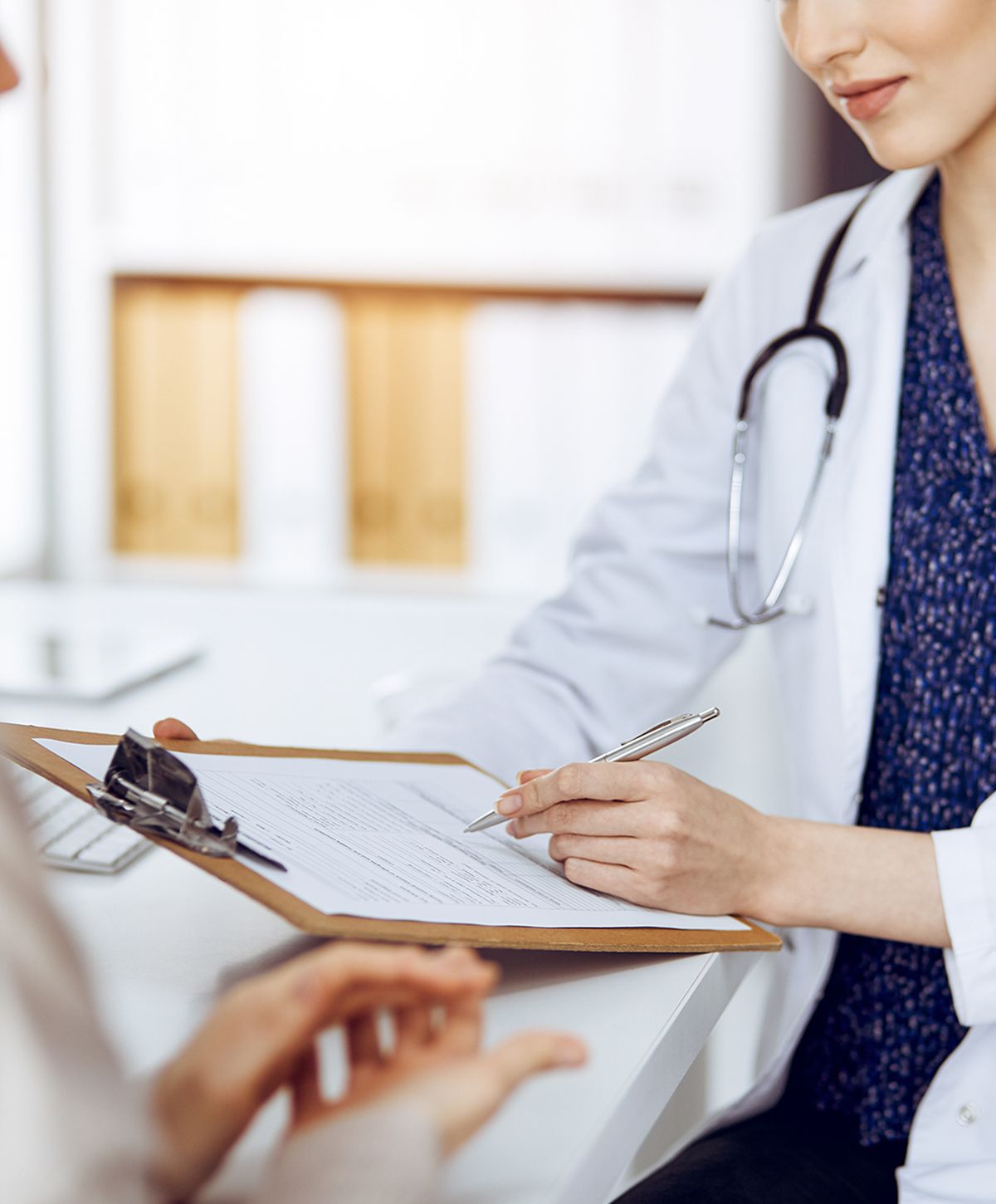 Doctor discussing patient paperwork in an office.